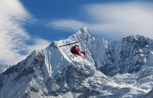 helicopter flying around mountain