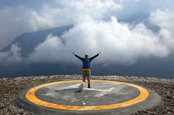 tourists raising arms for helicopter landing