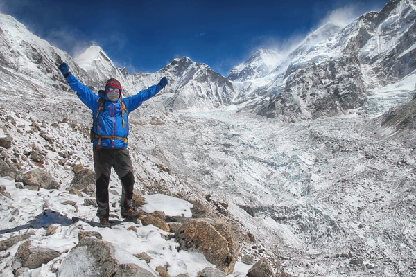 a hiker hands in the air at ebc