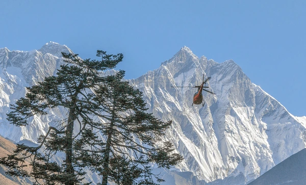 helicopter flying towards everest and lhotse