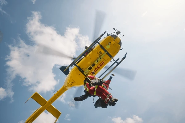 paramedics hanging in rope during helicopter rescue